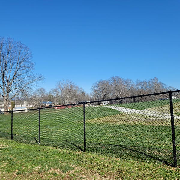 chain link fencing alongside a brick school building